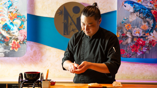 The chef preparing sushi at the counter