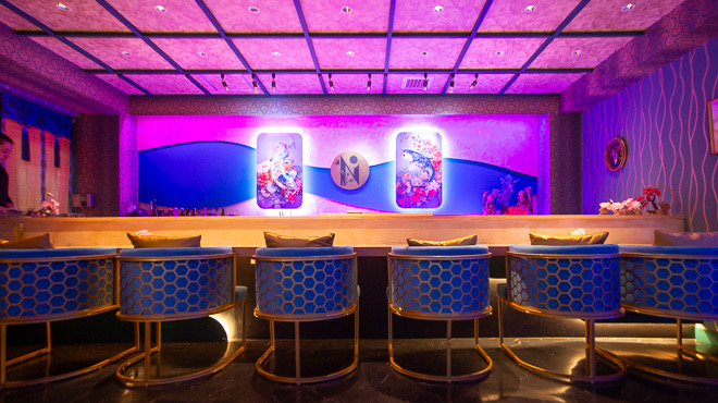 The eight-seat counter under vivid lighting